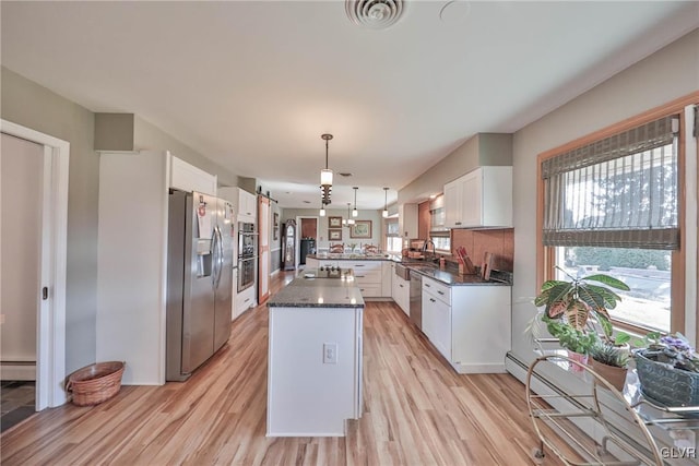 3332 Sherwood Rd, Palmer Twp, PA 18045 - kitchen featuring a peninsula, visible vents, light wood finished floors, and stainless steel appliances