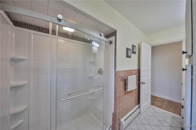 3332 Sherwood Rd, Palmer Twp, PA 18045 - full bath featuring baseboard heating, a shower stall, tile patterned floors, tile walls, and a wainscoted wall