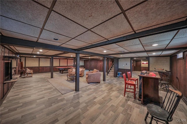 3332 Sherwood Rd, Palmer Twp, PA 18045 - interior space with stairway, wood walls, a drop ceiling, a bar, and light wood-style floors