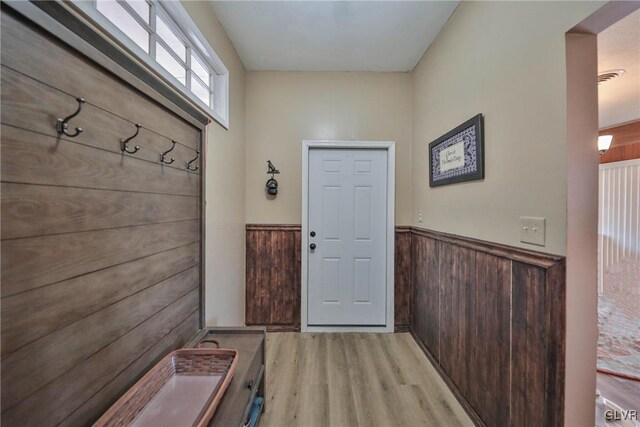 3332 Sherwood Rd, Palmer Twp, PA 18045 - mudroom with wooden walls, visible vents, a wainscoted wall, and light wood finished floors