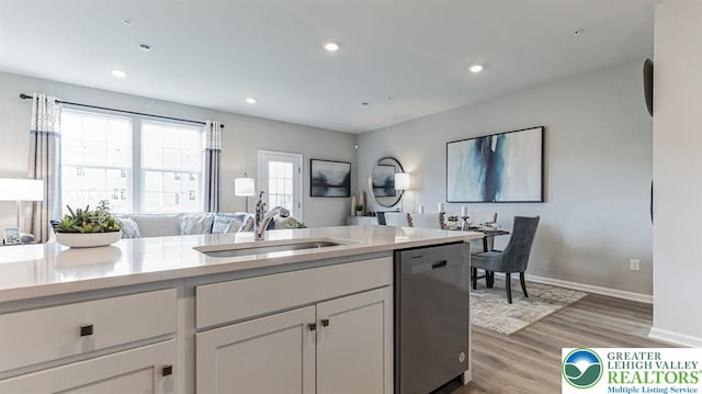 1205 Susan Cir, Upper Macungie Twp, PA 18031 - kitchen featuring light countertops, dishwasher, a sink, light wood-style floors, and open floor plan