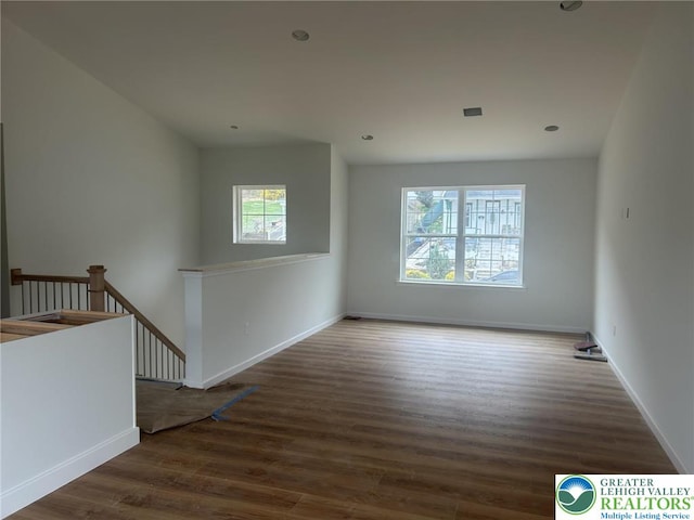 spare room featuring recessed lighting, wood finished floors, visible vents, and baseboards