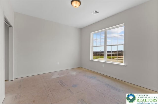 empty room with baseboards and visible vents