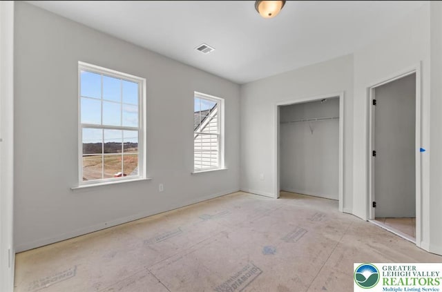 unfurnished bedroom featuring a closet, visible vents, and baseboards