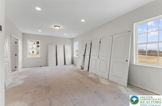 unfurnished bedroom with two closets and recessed lighting