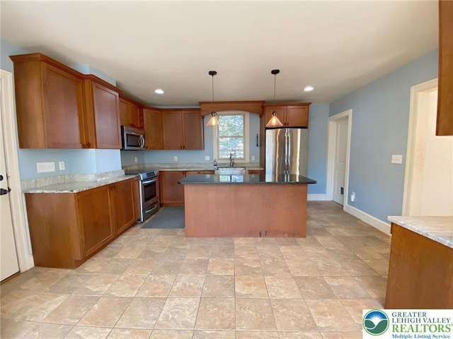 kitchen with brown cabinetry, a sink, recessed lighting, and appliances with stainless steel finishes