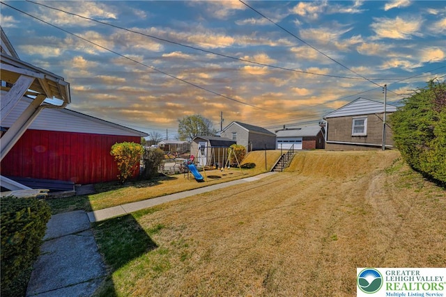 view of yard featuring an outbuilding and a playground