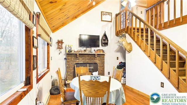dining area with stairway, wood finished floors, and a wealth of natural light