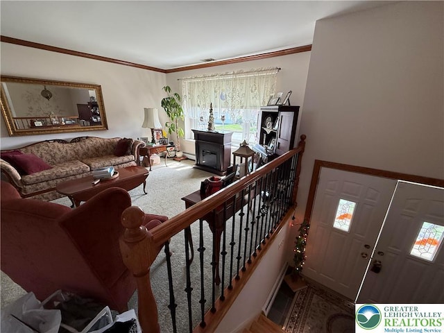 living room with visible vents, a healthy amount of sunlight, crown molding, and a baseboard radiator