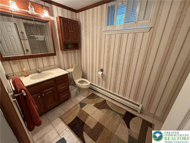 bathroom with vanity, tile patterned floors, toilet, ornamental molding, and a baseboard radiator