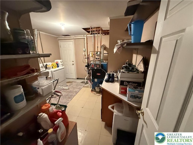 interior space featuring a heating unit, separate washer and dryer, and laundry area