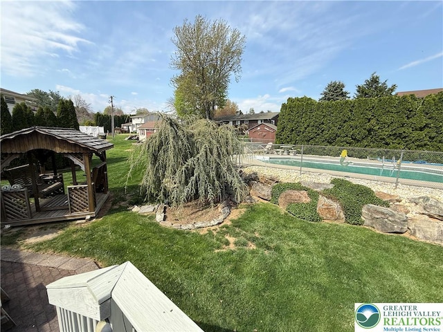 view of yard featuring a fenced in pool, a gazebo, and a fenced backyard