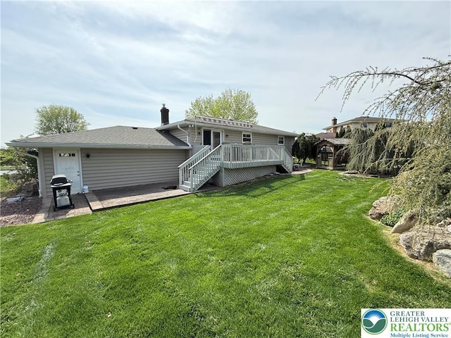 back of house with a lawn, stairway, and a deck