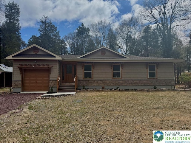 single story home featuring a front lawn, stone siding, dirt driveway, and an attached garage