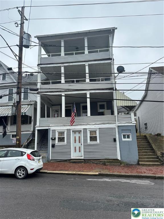 view of front of property featuring stairs