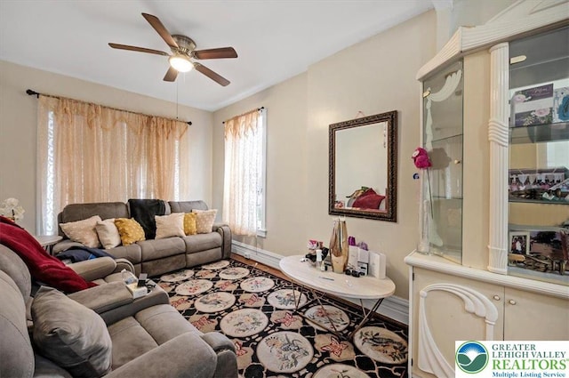 living area with wood finished floors, ceiling fan, and baseboards