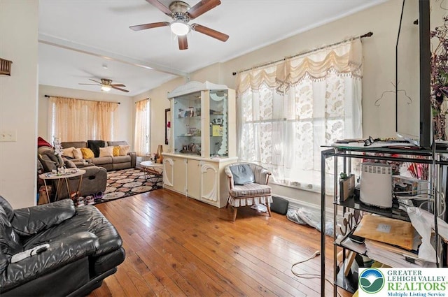 living area with a wealth of natural light, ceiling fan, and hardwood / wood-style floors