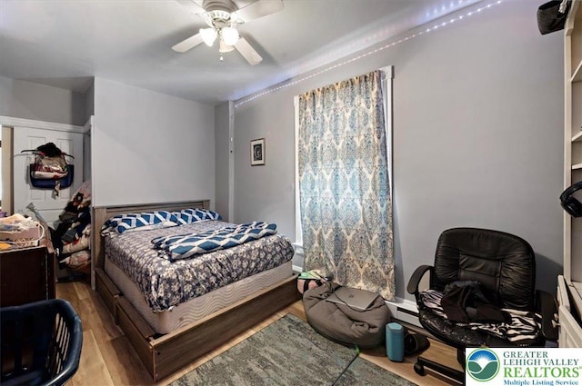 bedroom with wood finished floors and a ceiling fan
