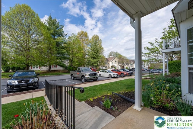 uncovered parking lot featuring a residential view