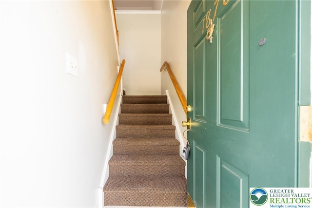staircase with carpet and baseboards