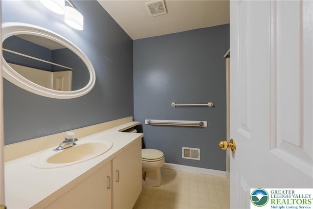 bathroom featuring tile patterned floors, visible vents, toilet, and vanity