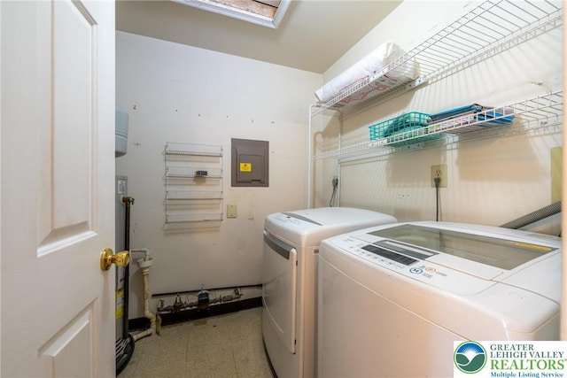 washroom with tile patterned floors, washer and clothes dryer, electric panel, and laundry area