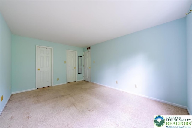 unfurnished room with baseboards and carpet floors