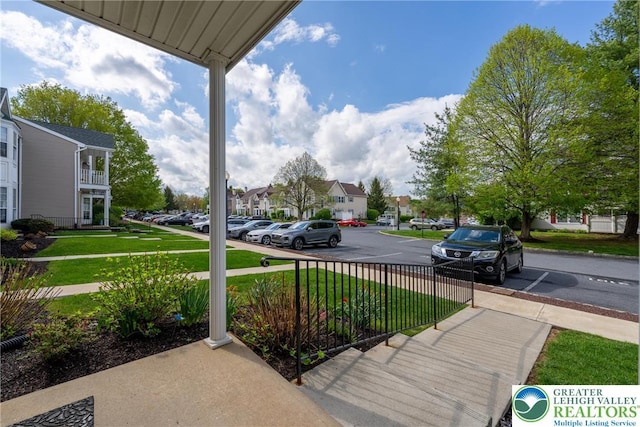 uncovered parking lot with a residential view