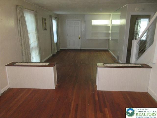 foyer entrance featuring wood finished floors and baseboards