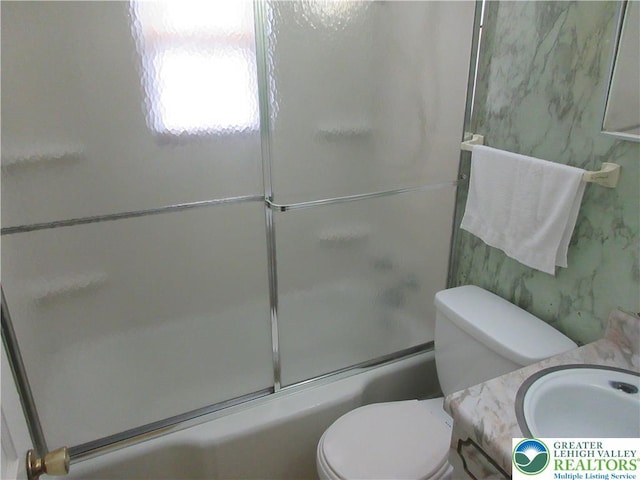 full bathroom with toilet, combined bath / shower with glass door, and vanity