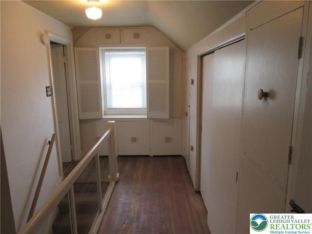 hallway featuring wood finished floors and vaulted ceiling