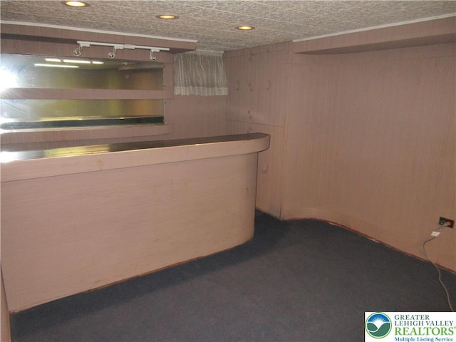 bar with recessed lighting, wooden walls, and a dry bar