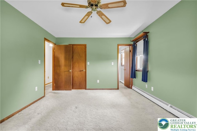 unfurnished bedroom with baseboards, ceiling fan, a baseboard heating unit, and carpet