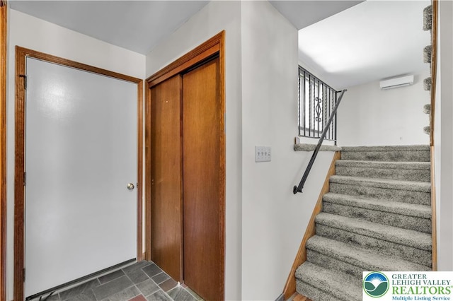 stairway featuring a wall mounted AC