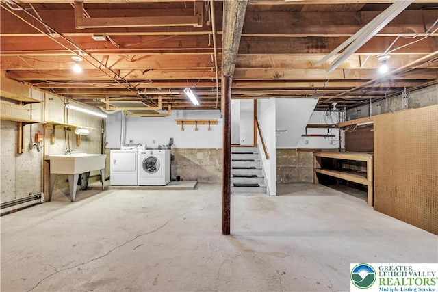 unfinished basement featuring separate washer and dryer, a sink, baseboard heating, and stairs