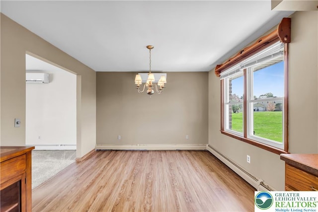 unfurnished dining area with an inviting chandelier, light wood-style floors, baseboards, an AC wall unit, and a baseboard radiator