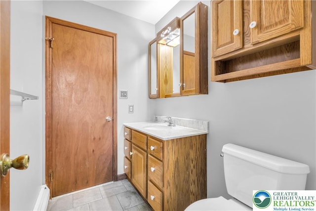 bathroom featuring tile patterned floors, vanity, and toilet