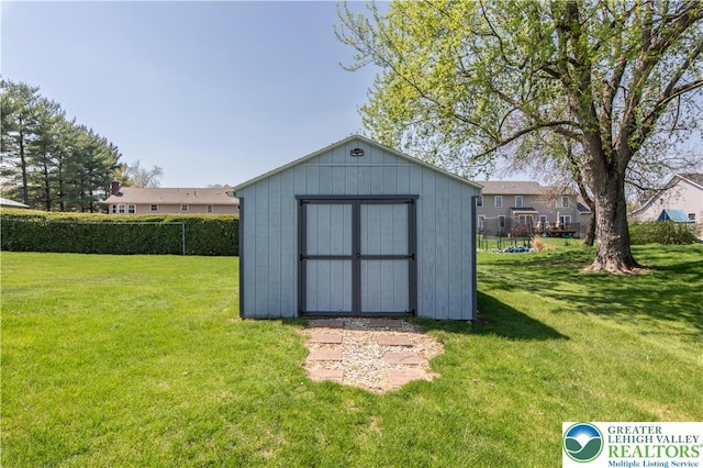 view of shed featuring fence