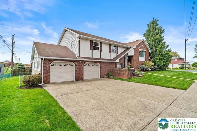 view of front of home featuring fence, concrete driveway, a front yard, and brick siding