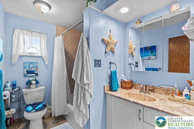 bathroom featuring toilet, shower / bath combo, and vanity