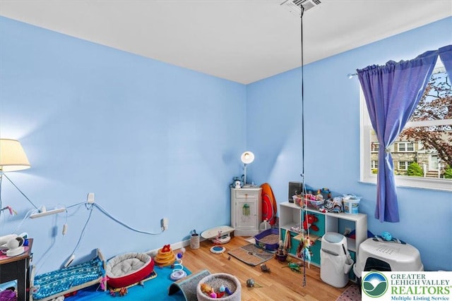 playroom with visible vents and wood finished floors