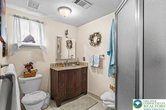 bathroom with tile patterned floors, toilet, visible vents, and vanity