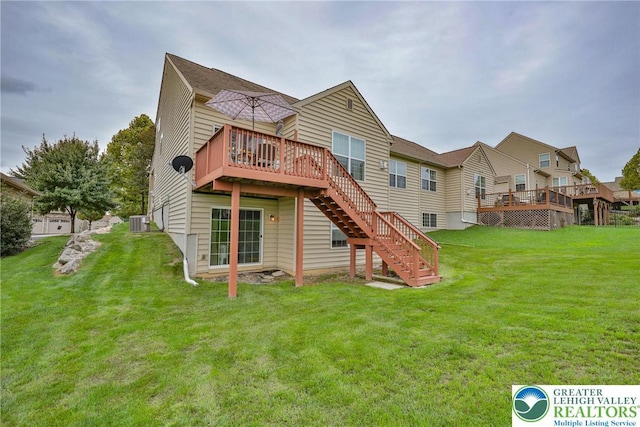 back of house with stairway, a yard, central air condition unit, and a wooden deck