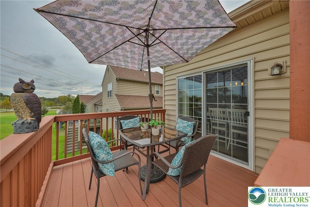 wooden deck featuring outdoor dining space