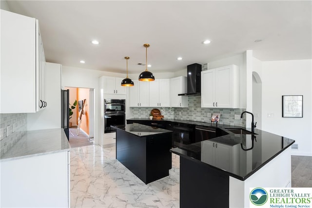 901 Meyer Rd, Bushkill Twp, PA 18064 - kitchen with a sink, wall chimney range hood, tasteful backsplash, arched walkways, and recessed lighting