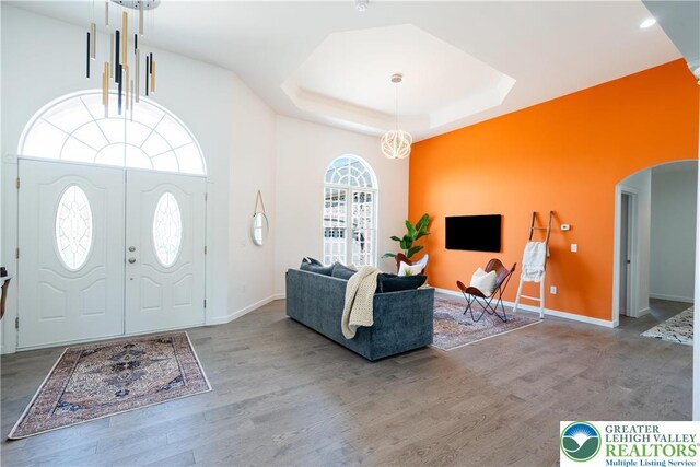 901 Meyer Rd, Bushkill Twp, PA 18064 - foyer entrance with arched walkways, wood finished floors, a tray ceiling, baseboards, and a high ceiling