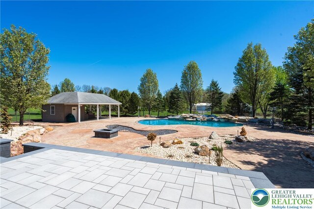 901 Meyer Rd, Bushkill Twp, PA 18064 - swimming pool with a patio, a fire pit, and an outdoor structure