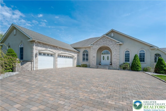 901 Meyer Rd, Bushkill Twp, PA 18064 - view of front of home featuring decorative driveway, a garage, and stucco siding