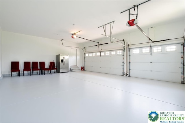 901 Meyer Rd, Bushkill Twp, PA 18064 - garage featuring stainless steel refrigerator with ice dispenser and a garage door opener