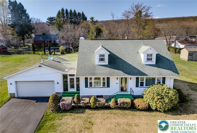cape cod house with a garage, aphalt driveway, and a front lawn